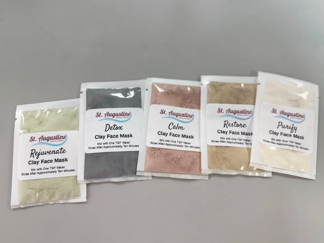 Five packets of St. Augustine Clay Face Mask on a gray background