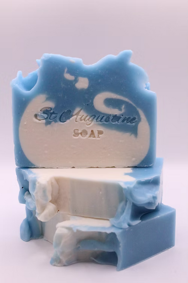 Blue and white soap with 'St. Augustine Soap' branding on a light gray background
